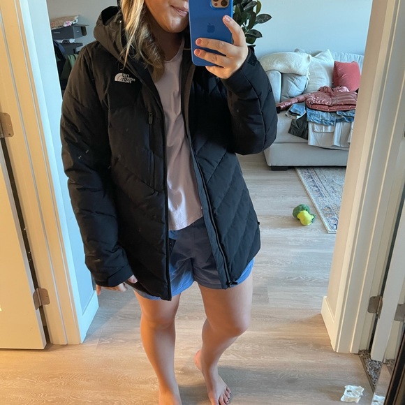 Black North Face goose down coat.